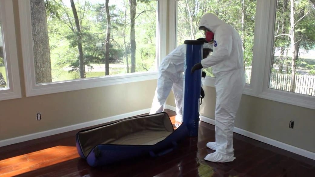 BioSweep technicians in protective equipment carrying out an odor treatment